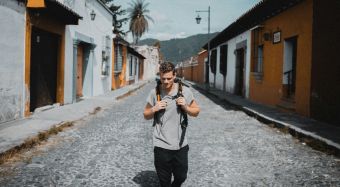 Traveler working on a laptop with portable Wi-Fi hotspot in a cafe