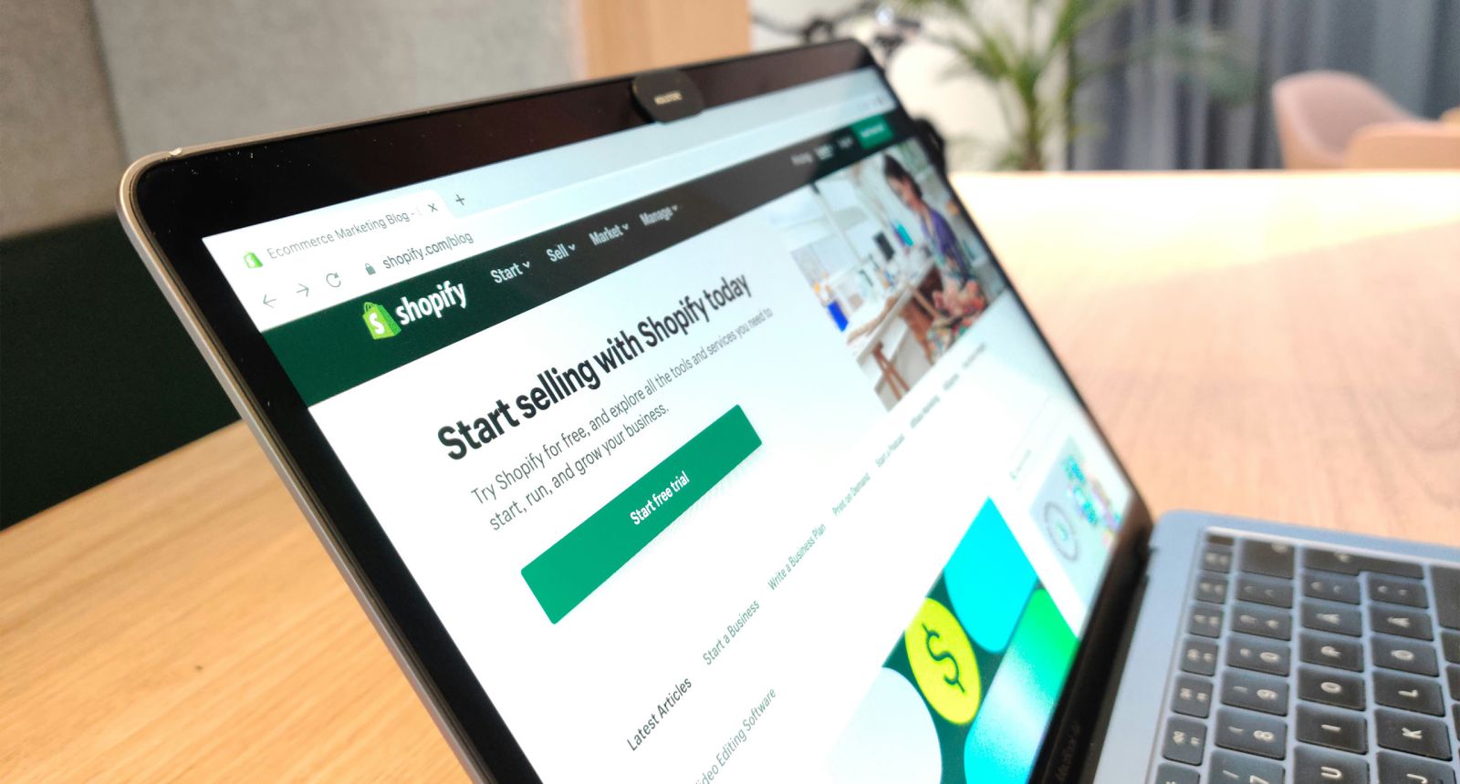 Comparison of ecommerce platforms, shopify shown on a laptop screen