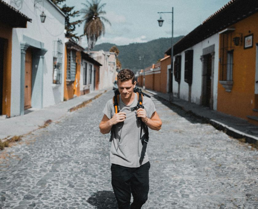 Traveler working on a laptop with portable Wi-Fi hotspot in a cafe
